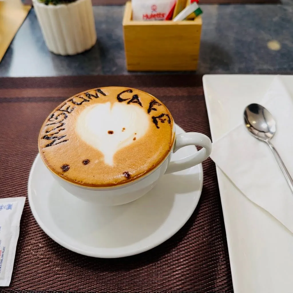 A cappuccino with Museum Cafe dusted across the foam