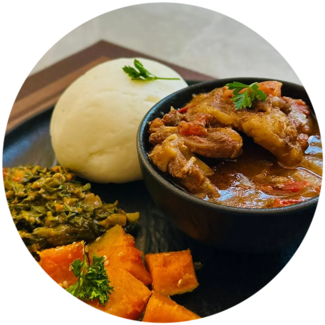 Seswaa in a cast iron pot with bogobe, morogo and roasted butternut