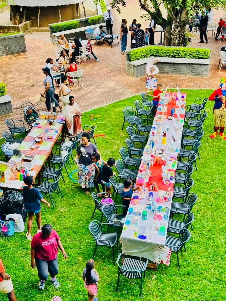 Long decorated tables set out on the lawn for a children's party