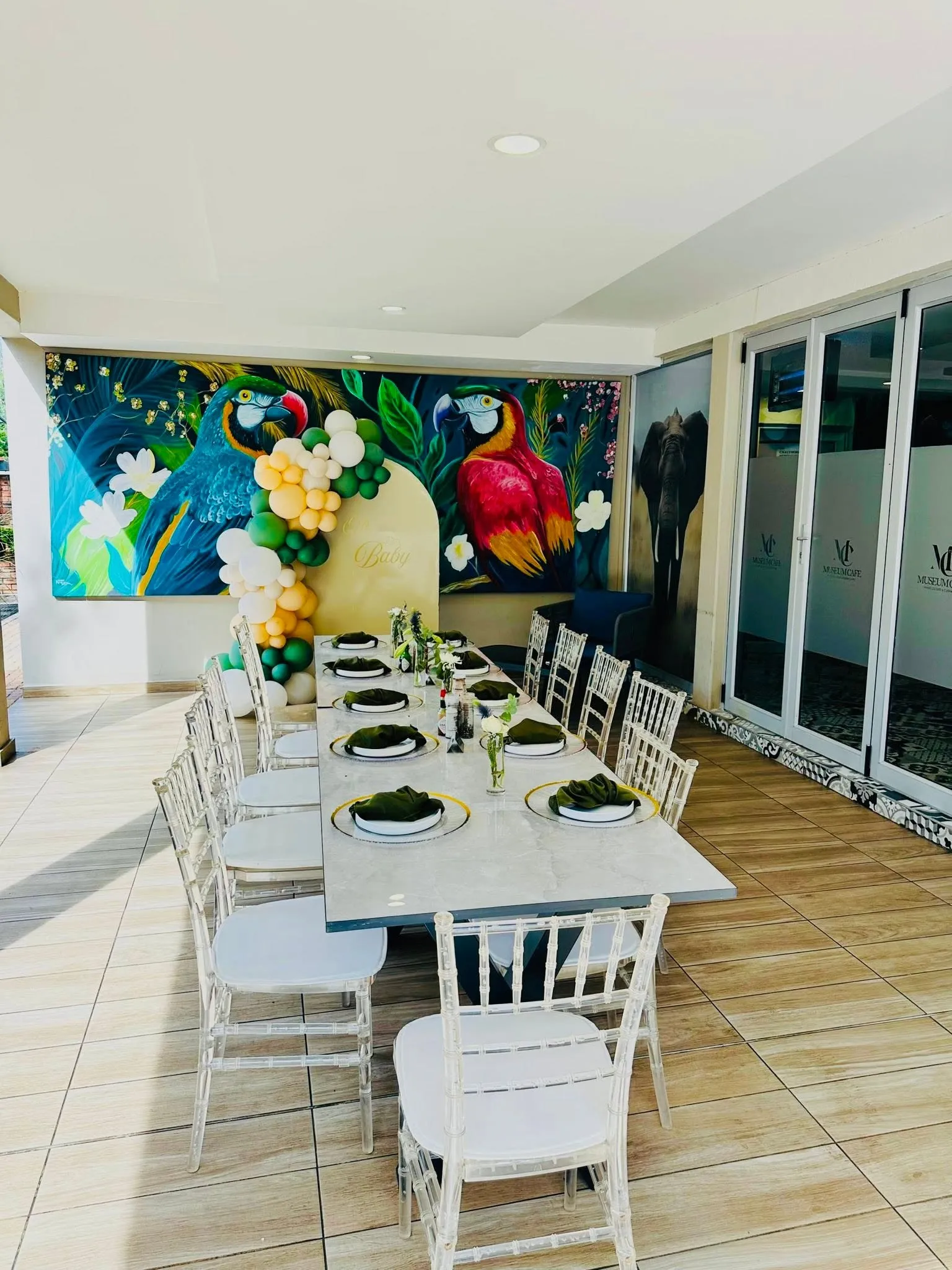 Indoor room styled with a dressed table and balloon installation
