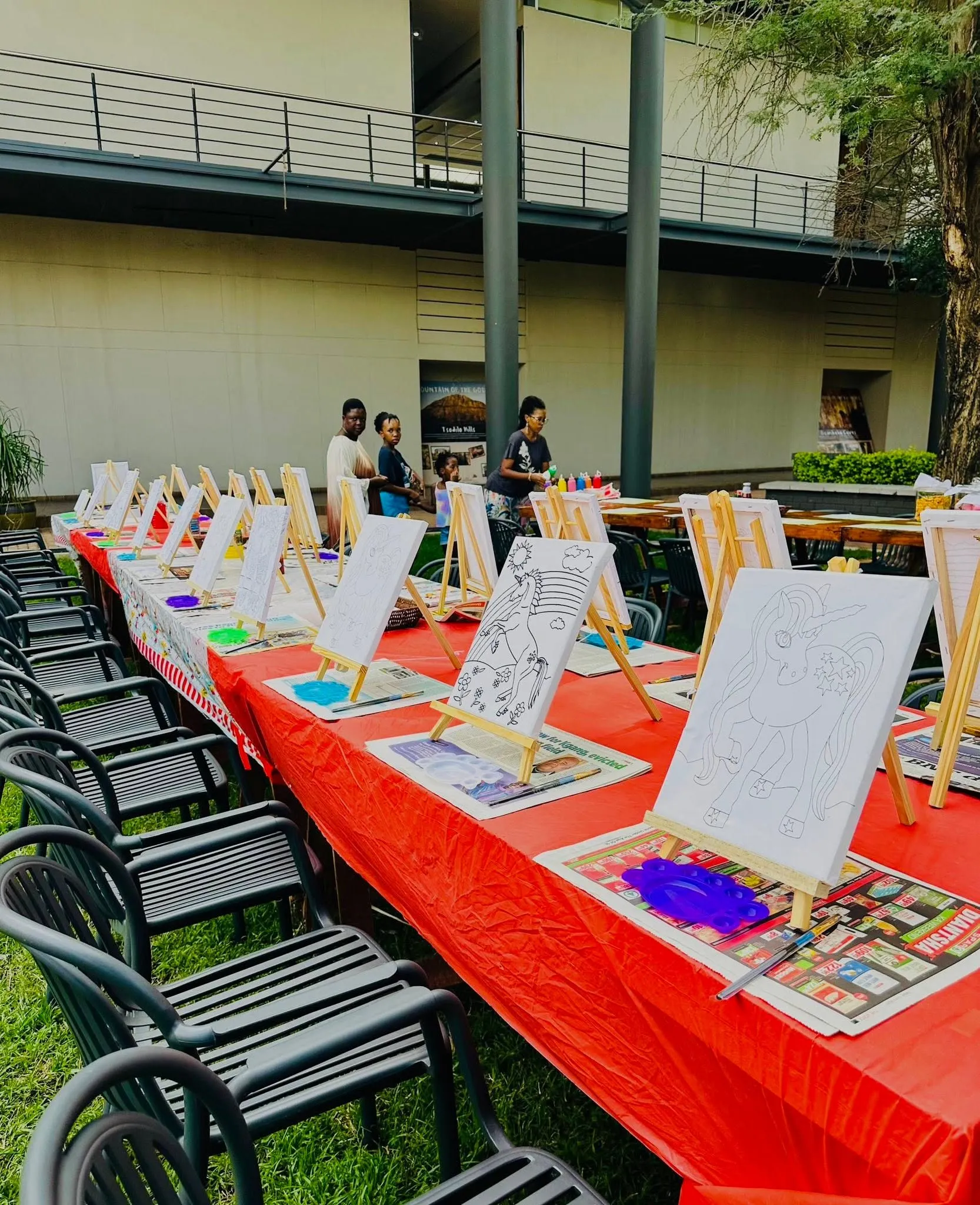 Long table set outdoors with display easels for a workshop